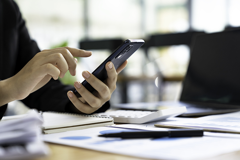 man holding a tablet and phone